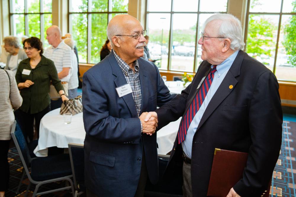 President Emeritus Don Lubbers shaking hands with a guest at the Retiree Reception.
